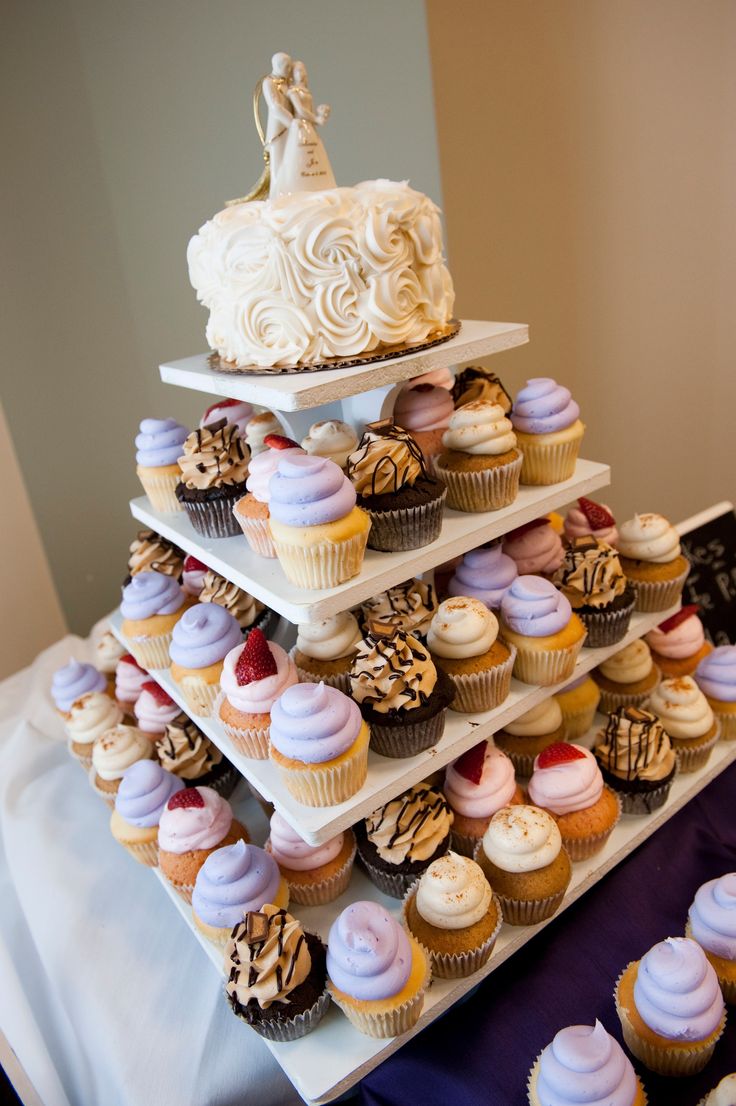 there are many cupcakes stacked on top of each other in the shape of a wedding cake