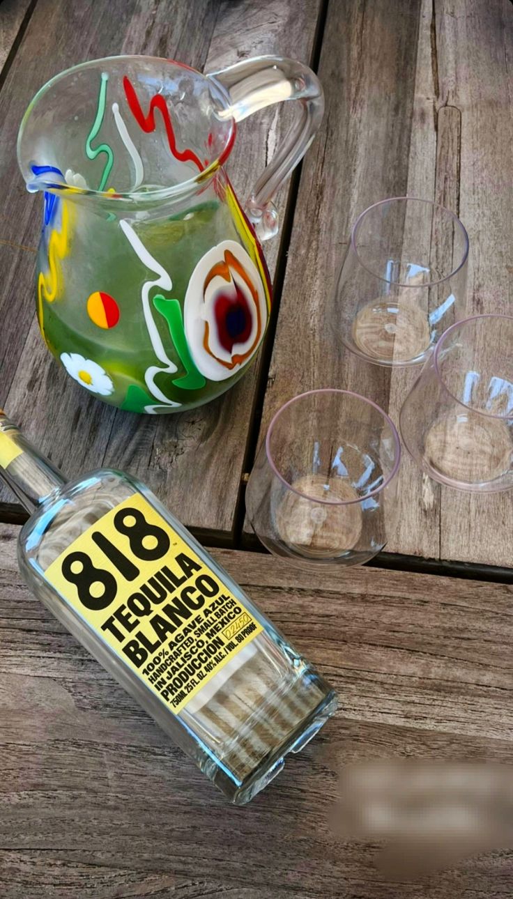 a bottle of alcohol sitting on top of a wooden table