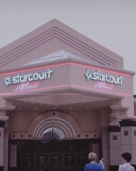 two people are standing outside the entrance to a starcout