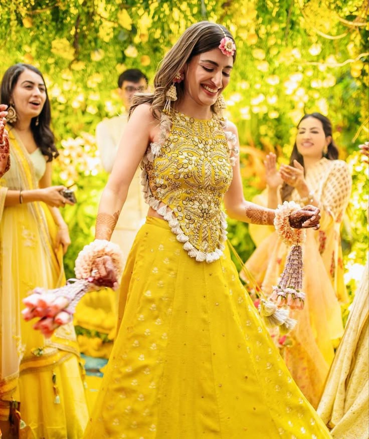 a woman in a yellow dress dancing with other people