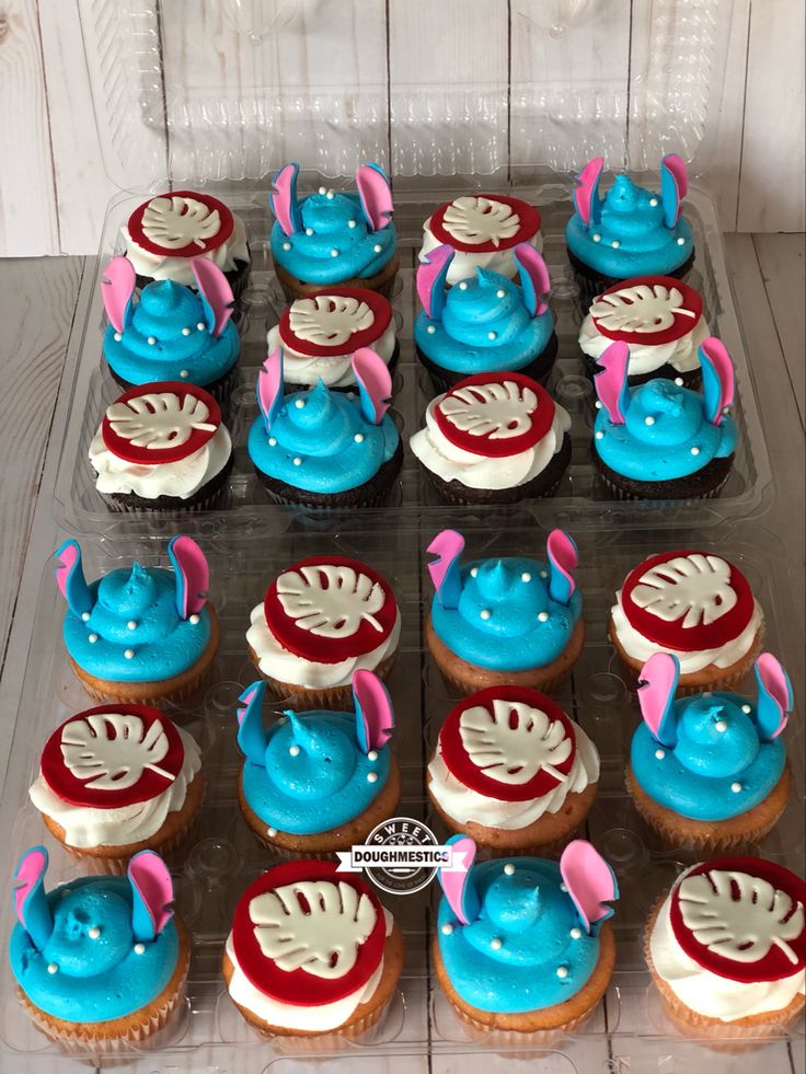 cupcakes with blue frosting and pink decorations