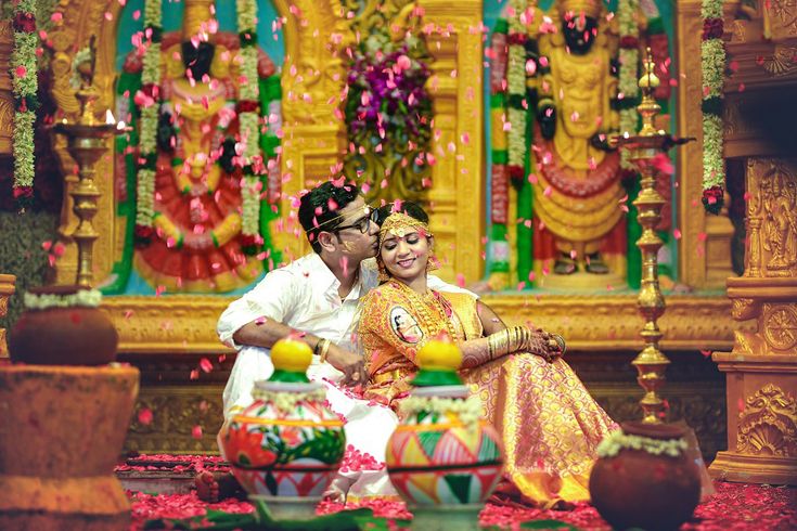 a man and woman sitting in front of a decorated stage