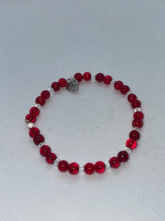 Red rounded beads complimented with clear rounded beads perfect for Valentines day. 20cm circumference 6.3cm diameter made with clear stretchy string. Can be made to any size on request. Will receive item in a gift bag. Red Stretch Bracelet For Valentine's Day Gift, Handmade Clear Beaded Bracelets As Gift, Clear Beaded Bracelets As A Gift, Clear Beaded Bracelets For Gift, Faceted Beads Stretch Bracelet Gift, Red Hand-strung Crystal Bracelet Gift, Red Adjustable Crystal Bracelet For Valentine's Day, Hand-strung Red Crystal Bracelet As Gift, Clear Beaded Stretch Bracelet As Gift