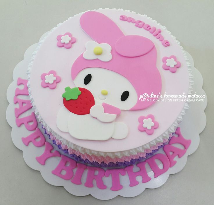 a birthday cake decorated with pink and white frosting, featuring an image of a bunny holding a strawberry