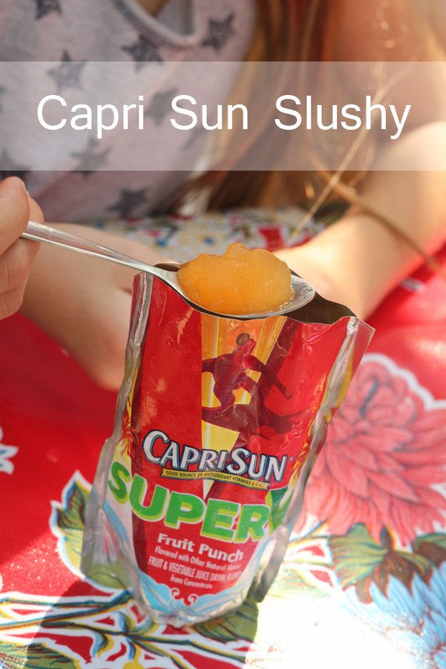 a girl is holding up a cup filled with sun slushy and the caption says, capri sun slushy