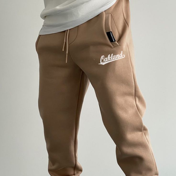 Oakland Fleece Sweatpants Fleece Joggers For Leisure, Casual Fleece Pants For Loungewear, Sportswear Bottoms With Ribbed Cuffs For Leisure, Comfortable Fleece Leisure Pants, Comfortable Fleece Pants For Leisure, Sporty Beige Sweatpants For Streetwear, Relaxed Fit Fleece Bottoms With Letter Print, Casual Beige Sweatpants For Winter, Sportswear Fleece Pants With Ribbed Cuffs