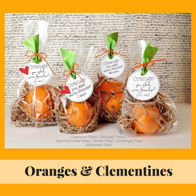 oranges and clementines are wrapped in clear cellophane to give as favors