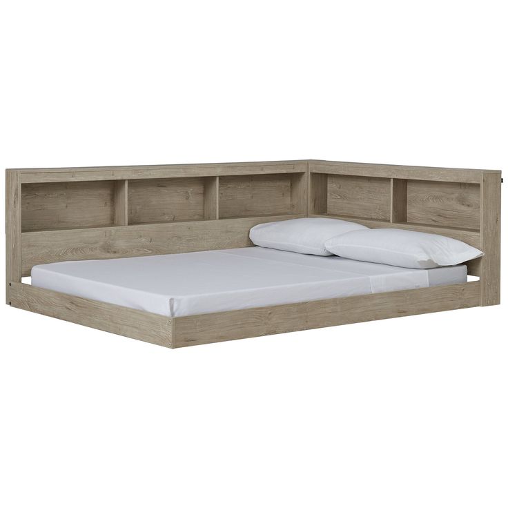 a bed with a headboard made out of wood and white sheets on top of it