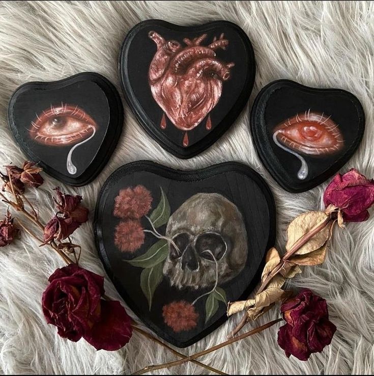 three heart shaped boxes with skulls and flowers