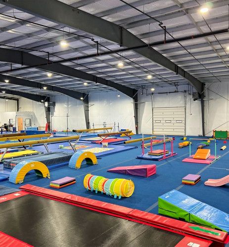 an indoor trampoline gym with several different types of trampolines and obstacles