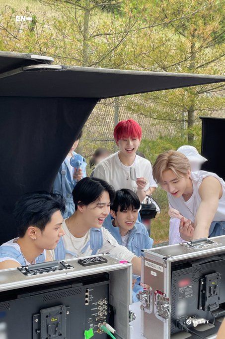 group of young men standing in front of computer monitors