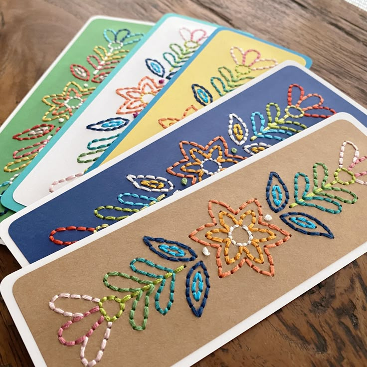 three handmade placemats sitting on top of a wooden table next to each other