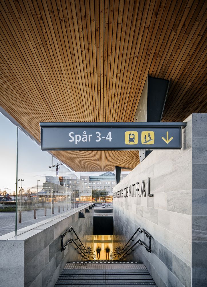 an escalator with stairs leading up to the entrance