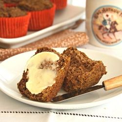 a white plate topped with cupcakes and a knife