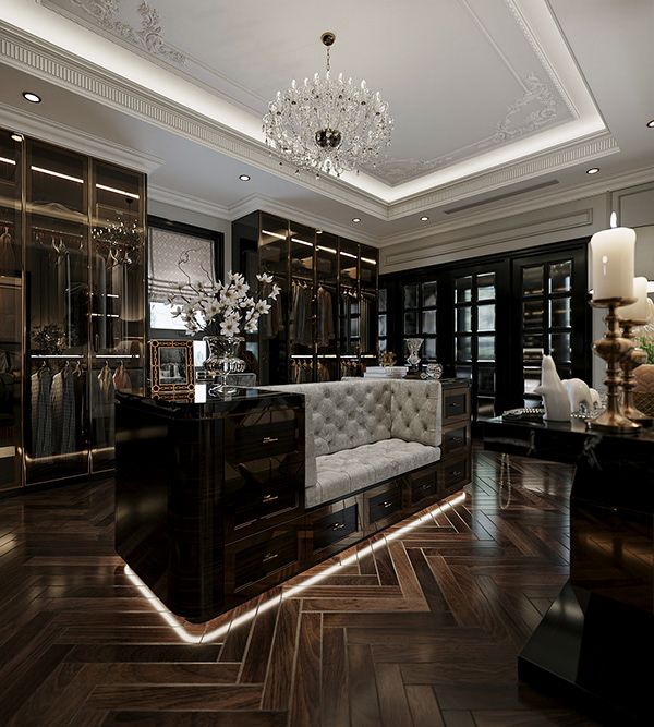 a living room filled with furniture and a chandelier hanging from the ceiling over a wooden floor