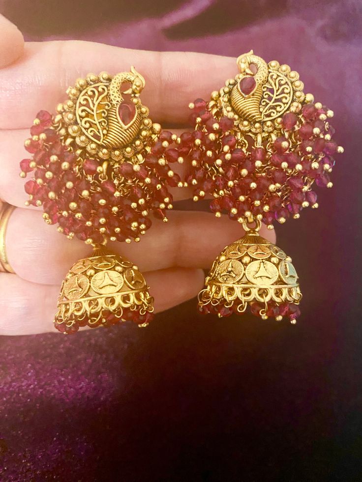 These Antique Peacock Earrings are a must-have for any fashion-forward individual. Each pair boasts intricate designs and is available in four stunning colors. Perfectly complement any Indian outfit with these unique earrings. Length - 6 cm Jewellery Care- Keep the jewelry dry, avoid heat and contact with perfumes & water. Red Chandbalis For Festive Occasions, Red Chandbalis For Celebration, Red Jhumkas With Intricate Design For Celebration, Red Earrings With Intricate Design For Festive Season, Red Earrings For Festivals, Red Drop Jhumkas For Party, Red Temple Jewelry Earrings, Elegant Red Bridal Earrings With Latkans, Elegant Red Chandbalis For Celebration