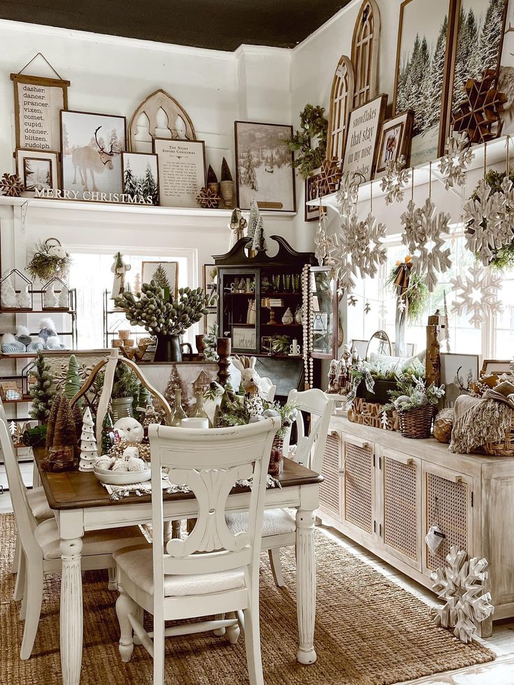 a room filled with lots of furniture and pictures on the wall next to a table