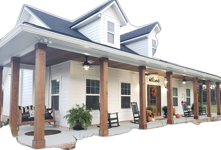 a white house with porches and rocking chairs on it's front porch area