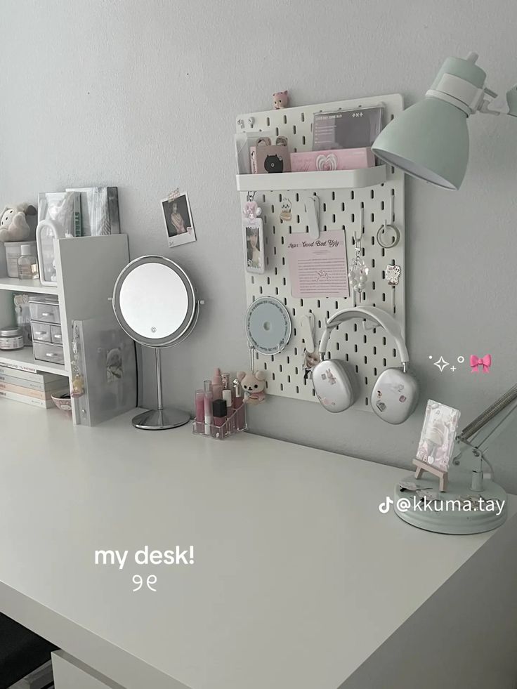 a white desk topped with lots of clutter