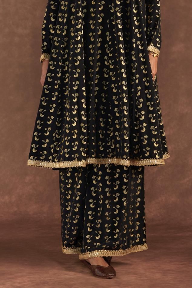 Black anarkali with all-over springbud foil prints. Comes with culotte and dupatta with embroidered border and kinari.
Components: 3
Pattern: Foil Printed, Embroidered
Type Of Work: Springbud
Neckline: Round
Sleeve Type: Full
Fabric: Anarkali and Culotte- Crepe Silk, Dupatta- Organza
Color: Black
Other Details: 
Disclaimer: The actual print-placement and colour of the product may vary slightly from the image shown.
Occasion: Sangeet - Aza Fashions Black Anarkali, Foil Prints, Embroidered Border, Silk Dupatta, Print Placement, Foil Print, Set For Women, Anarkali, Aza Fashion