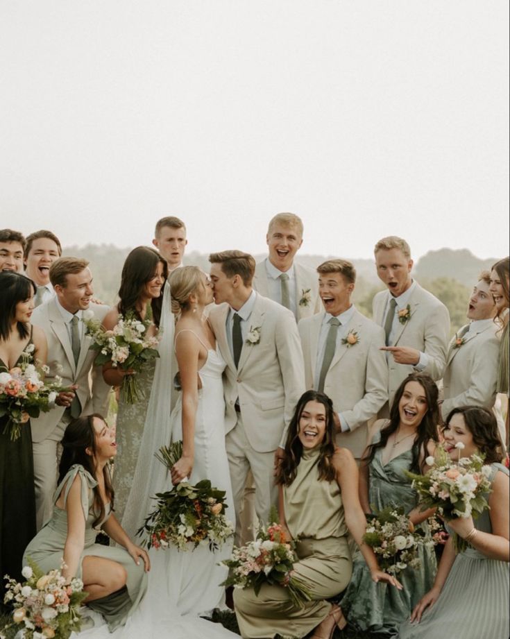 a group of people that are standing in front of each other wearing suits and ties