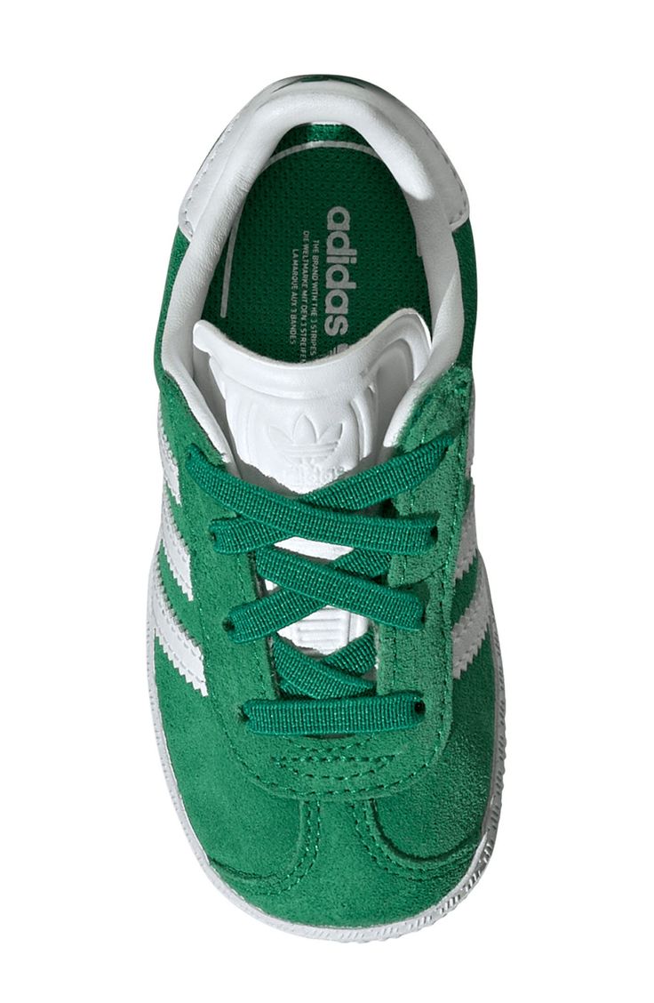 Initially designed in '91 as a training shoe for top athletes, the iconic Gazelle sneaker has been refreshed with stretchy laces for your little athlete. Pull-on style with elastic laces Leather and synthetic upper/textile lining/rubber sole Imported Green Adidas Sneakers With Laces, Green Sneakers With Laces For Jogging, Green Lace-up High-top Sneakers For Jogging, Green Adidas High-top Lace-up Sneakers, Low-top Training Sneakers With Laces, White High-top Sneakers With Elastic Laces For Jogging, Green Lace-up High-top Sneakers With Adidas Logo, Low-top Training Sneakers, Sporty Green Sneakers For Training