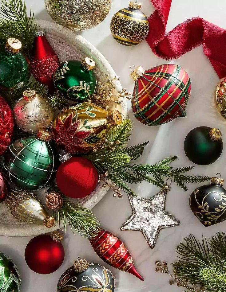 a bowl filled with christmas ornaments on top of a table