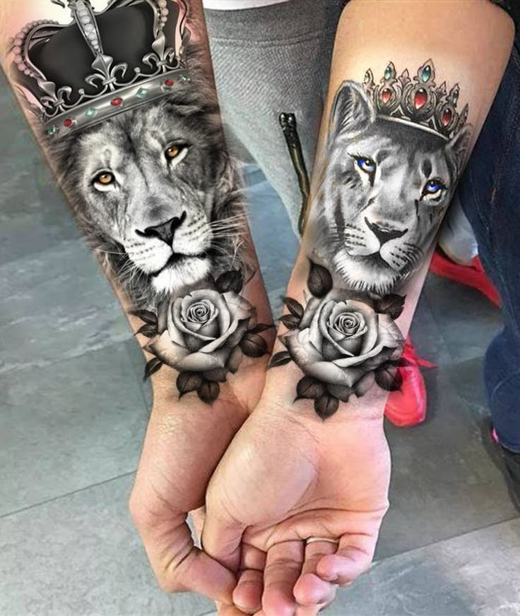 two people holding hands with tattoos on their arms and one has a lion, the other is