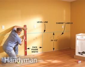 a man is working on the wall in his living room, with measurements and instructions