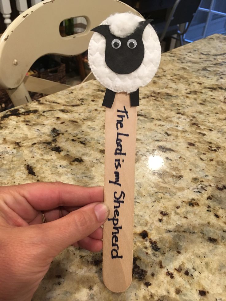 a hand holding a wooden stick with a sheep on it that says, i'm the first step forward