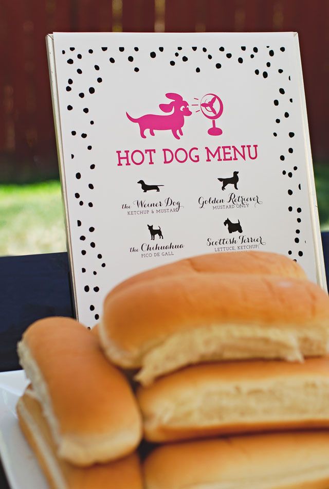 hot dogs are stacked on top of each other in front of a sign that says hot dog menu