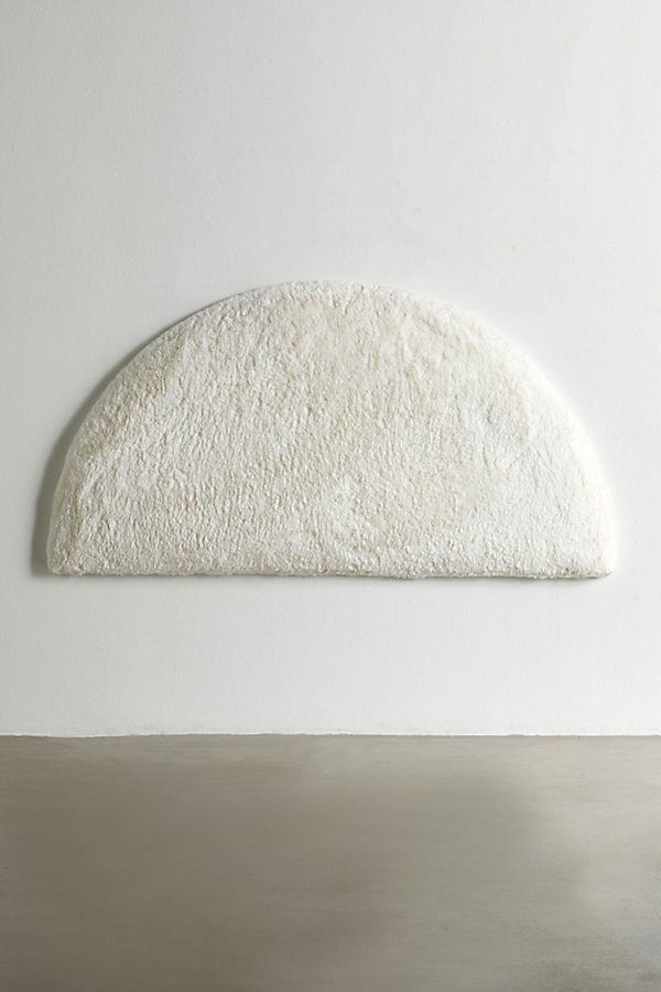 a white wall with a round shaped object on it