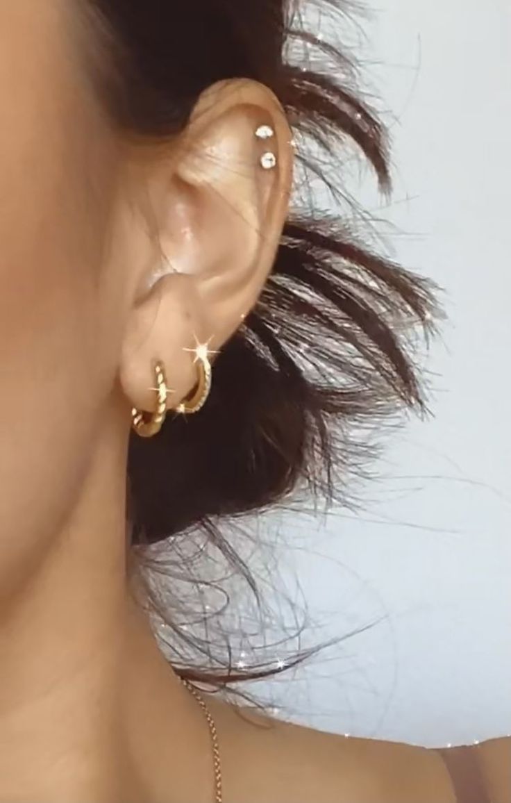 a close up of a person with ear piercings