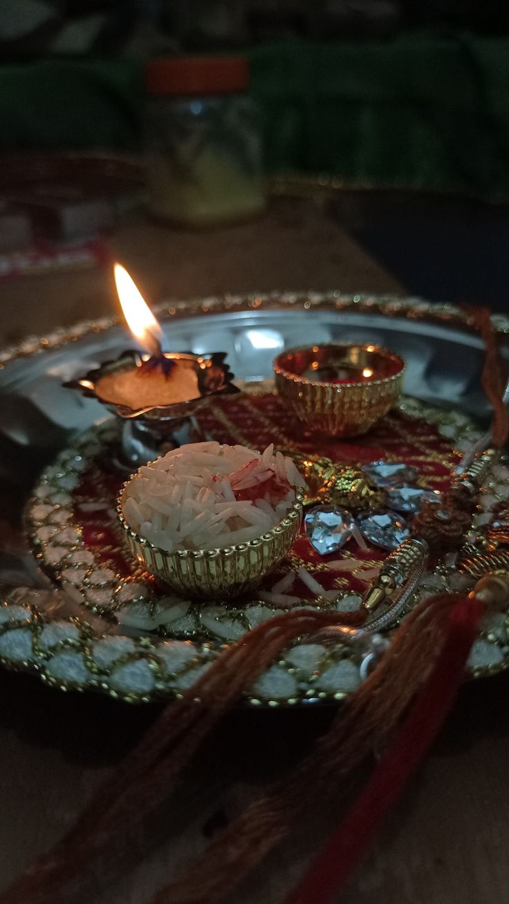 a plate with some food on it next to a lit candle