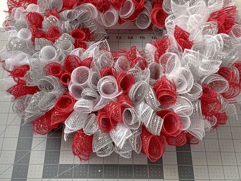 a red and white wreath sitting on top of a table