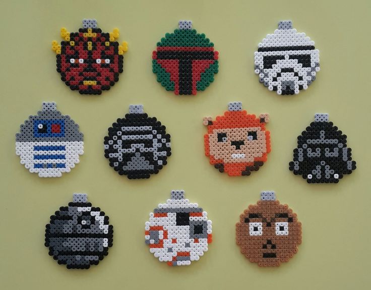 six star wars bead magnets are arranged on a table