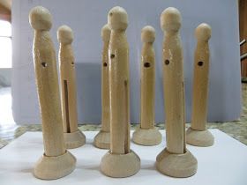 six wooden pegs are lined up in a row on a counter top, with one standing out from the others