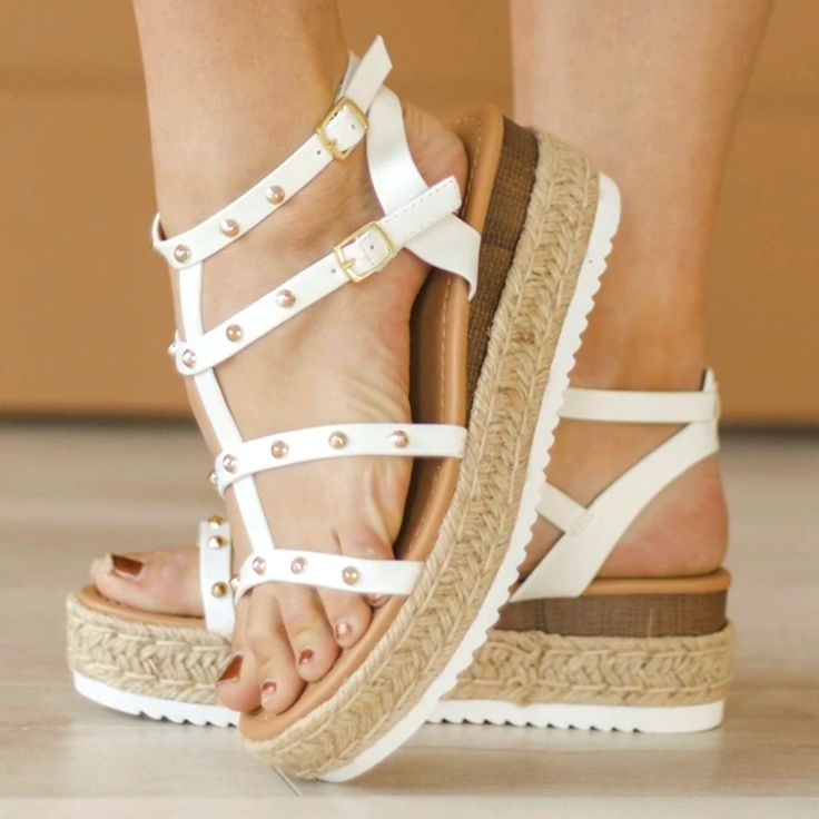 These Studded Wedge Sandals Are A New Fav For Spring. Features Gold Studs On Straps And Two Buckles On The Sides. Bottom Buckle Has Velcro Option For Easy Adjustment. Espadrilles Detail Platform Platform: Front- 1.5" Back- 2" New White Wedge Sandals For Summer Beach, White Platform Sandals For Vacation, White Wedge Sandals For Summer, White Open Toe Wedge Sandals For Beach Season, White Round Toe Wedge Sandals For Beach Season, White Wedge Heel Sandals For Beach Season, White Synthetic Wedge Sandals For Beach, White Wedge Sandals For Beach Vacation, White Wedge Sandals For Beach Season