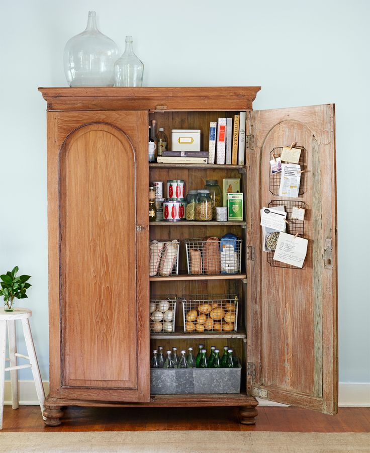 an old wooden cabinet with many items in it