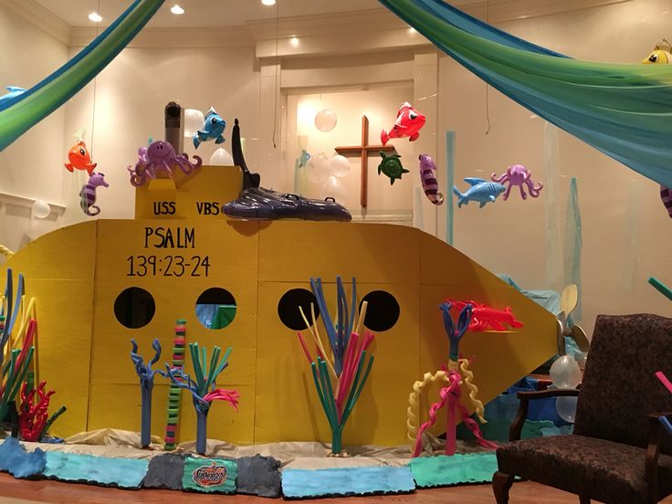 a yellow submarine boat made out of construction paper with sea creatures on the front and sides