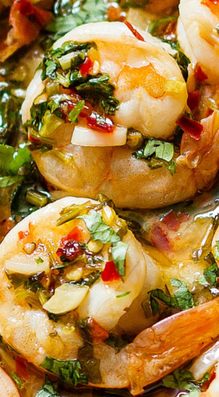 closeup of cooked shrimp with spinach and other vegetables