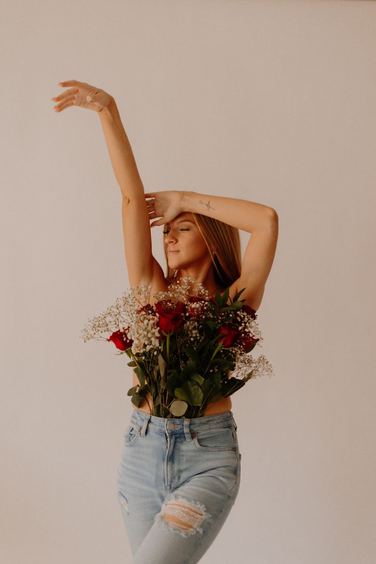 a woman with flowers in her hair and jeans