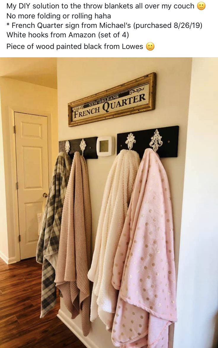 towels are hanging on the wall next to a coat rack