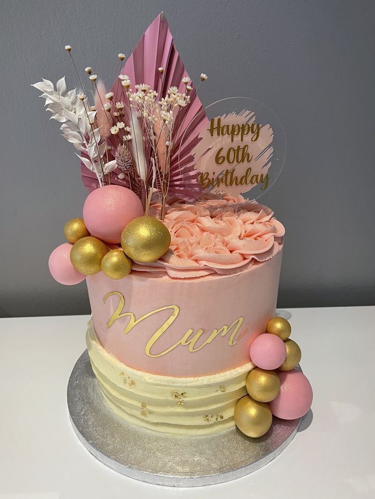 a birthday cake with pink and gold decorations