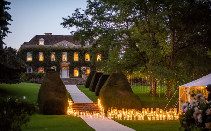 candles are lit in front of a large house