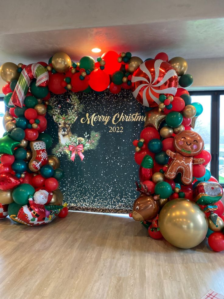 christmas decorations are displayed on the floor in front of a large sign that says merry christmas