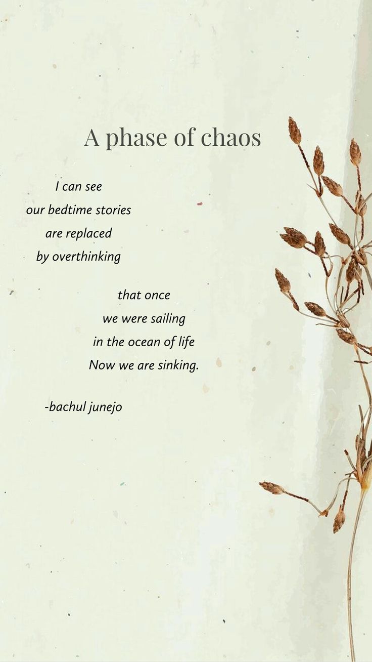 a close up of a piece of paper with words on it and plants in the background