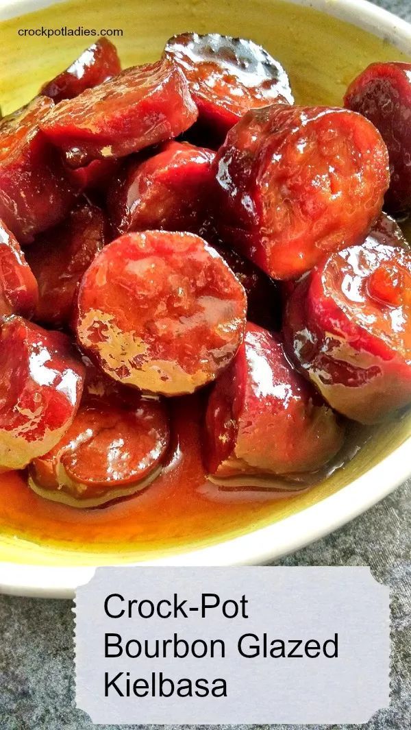 a yellow bowl filled with cooked tomatoes covered in ketchup on top of a table