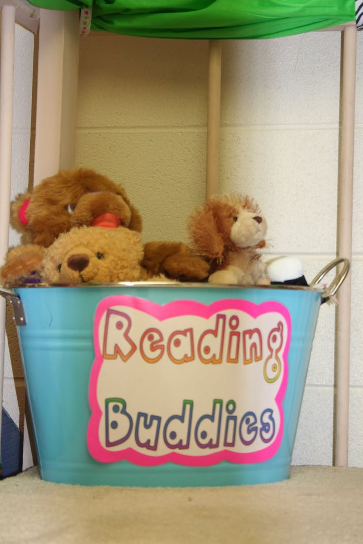 teddy bears are sitting in a bucket reading buddies on the shelf above them is a sign that says bedding buddies