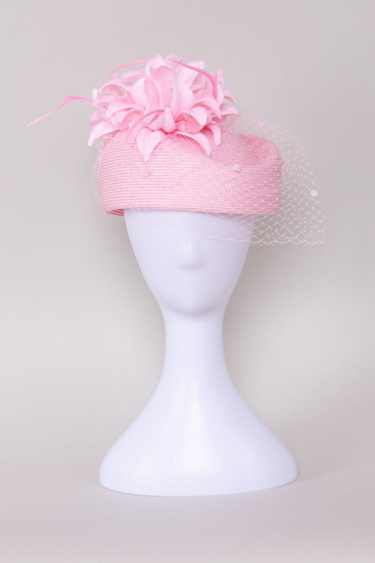 Add a touch of timeless elegance to your ensemble with our classic Timeless Grace Pillbox Hat. This sophisticated accessory is adorned with a matching veil featuring playful pom poms, adding a hint of whimsy to its refined charm. The dainty flower, embellished with shimmering rhinestones, adds sparkle and glamour, while delicate feathers sway gracefully with every movement, elevating your look with a graceful air. NO RETURNS/EXCHANGES due to the nature of the product (special occasions and headw Chic Pink Hat For Wedding, Chic Pink Wedding Hat, Elegant Pink Headpiece With Structured Crown, Pink Mini Hats For Kentucky Derby Ceremony, Formal Mini Hats With Handmade Flowers, Elegant Pink Fascinator For Ceremony, Flower Shaped Mini Hats For Evening, Adjustable Pink Hat For Ceremony, Pink Adjustable Hat For Ceremony